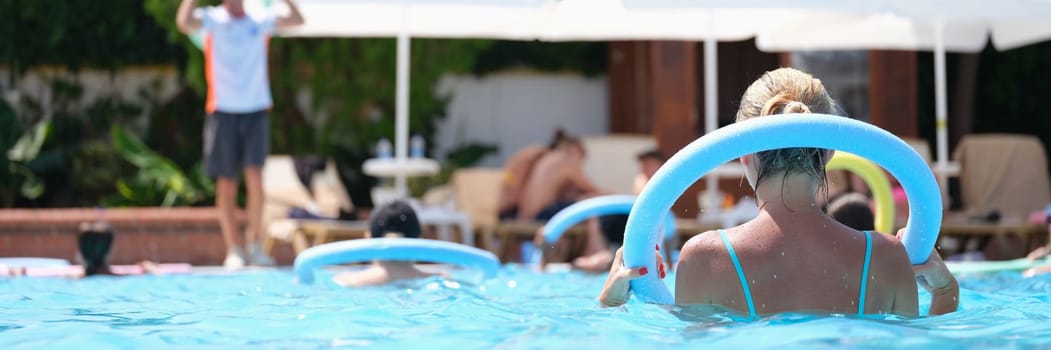 People do aqua aerobics in noodle pool