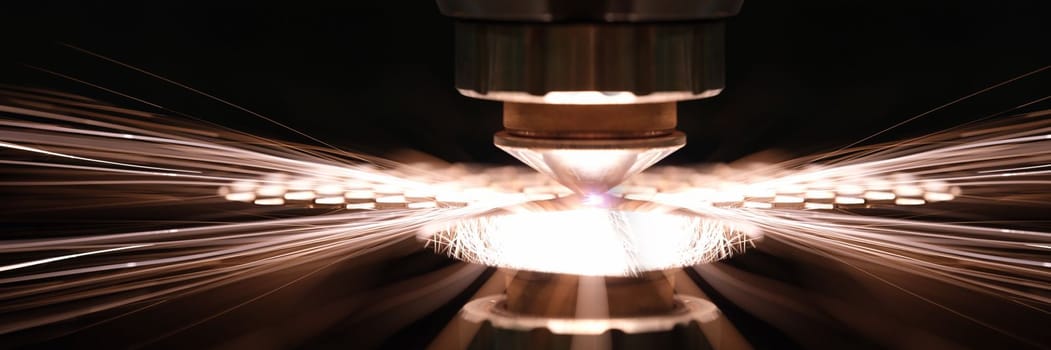 Laser cutting of metal sheet in production closeup