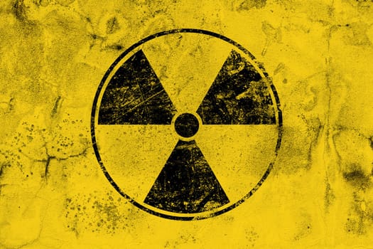 Black radioactive sign over yellow background