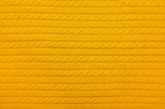 Background texture of yellow knitted wool fabric