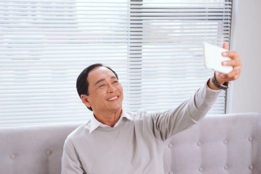 Asian senior man with tablet pc computer make video call