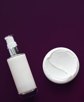 Beauty cosmetics and skincare product on purple background, flatlay