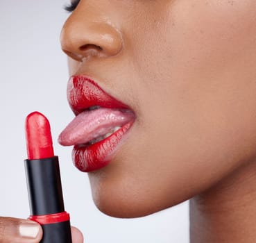 Obsessed with this colour. Cropped studio shot of an unrecognizable woman wearing bright red lipstick against a grey background
