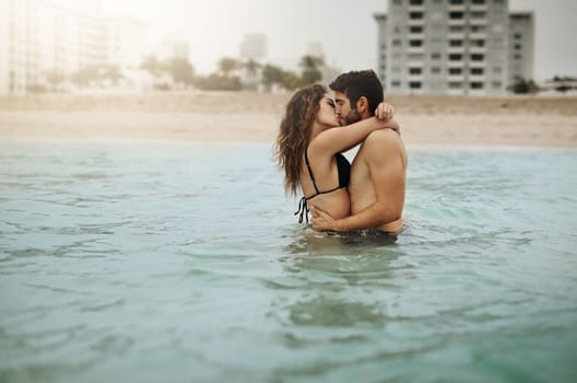 Sharing a passionate kiss. an affectionate couple spending some time in the water.