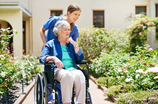Where to next. a resident and a nurse outside in the retirement home garden.