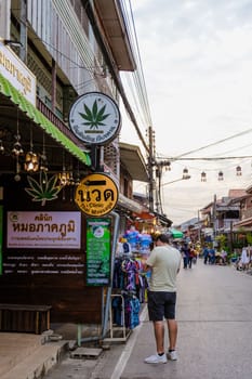 Chiang Khan village tourist outside a cannabis Marijuana shop in the village of Chiang Khan
