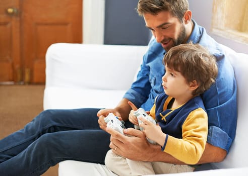 Youre really good at this. a father and his young son playing video games