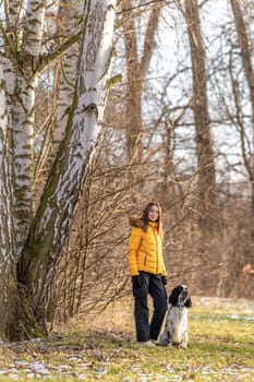 teenager in the park with a dog. english setter