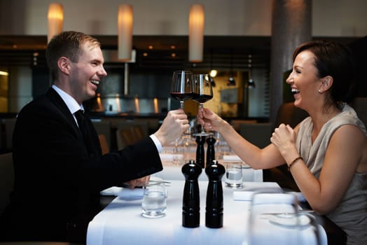 Toasting a special occasion. a couple having dinner in a restaurant.