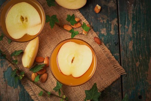 Hot drink of apple tea with cinnamon stick. Hot drink with apples for autumn or winter.