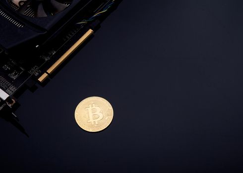 bitcoin and video card on black background