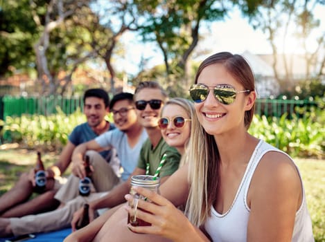 This is the best. Cropped portrait of an attractive young woman enjoying a few drinks with friends outside in the summer sun.