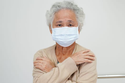 Asian elderly woman patient wearing a mask for protect Covid-19 Coronavirus.