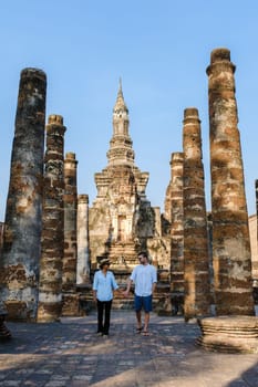 Asian women and Caucasian men visiting Wat Mahathat, Sukhothai Thailand. Sukothai historical park