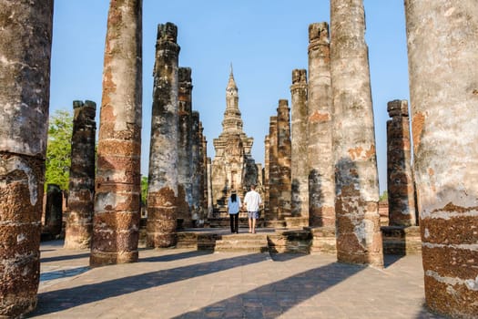 Couple visit Wat Mahathat, Sukhothai old city, Thailand., Sukothai historical park Thailand