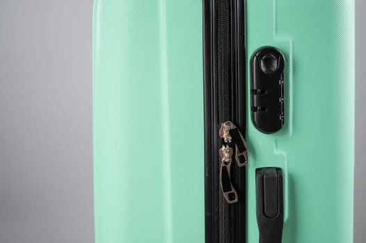 Close-up of a combination lock of a mint plastic suitcase.