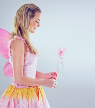Shes ready to make magic happen. A cropped shot of a cute fairy dressed in pink.