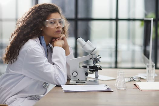 Young woman in biological laboratory. Attractive young female scientis.