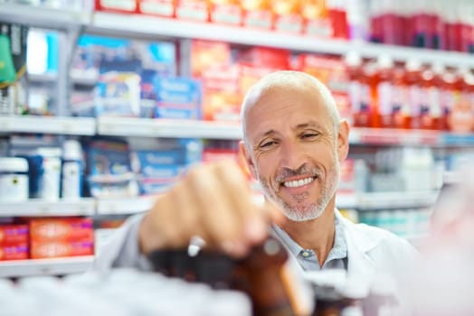 Maintaining a well-stocked pharmacy. a mature pharmacist working in a chemist.
