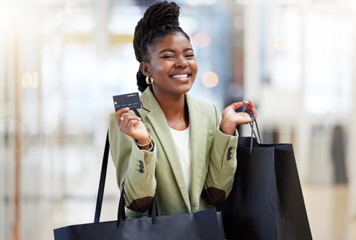 Invest in your financial future. a young woman using her bank card to pay for a day of fun shopping.