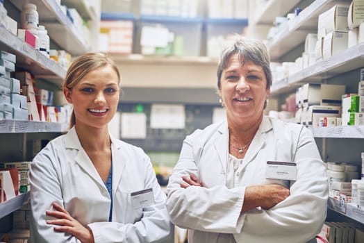 Well help you get well as quickly as possible. Portrait of pharmacists standing in a isle with their arms crossed.