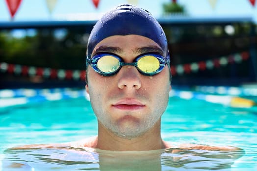 Born to swim. Cropped portrait of a male swimmer looking serious while in the pool.