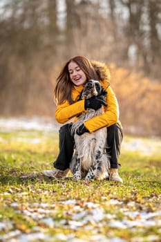 young teenage girl plays with her dog in nature. english setter