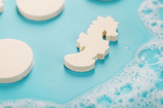 Soap in the shape of a seahorse and circles with foam
