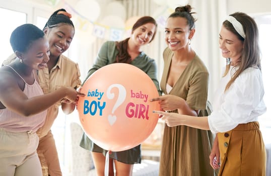 Which will it be. a group of women about to pop a balloon for a gender reveal during a baby shower.