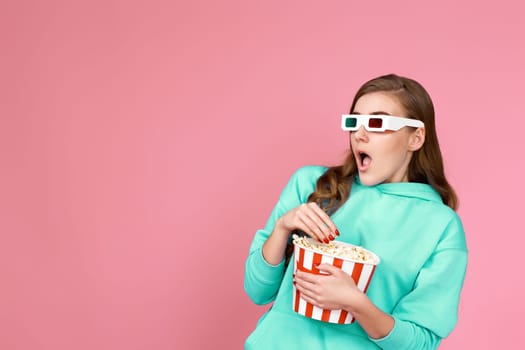 woman in sweatshirt holding bucket of popcorn