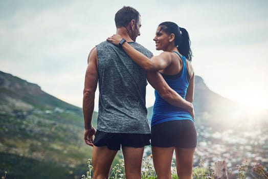 Thank you for helping me get fit. a young attractive couple training for a marathon outdoors.