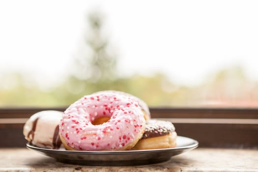 Plate with donuts next to window