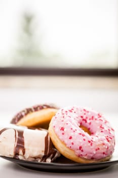 Plate with donuts next to window