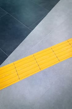 Footpath or yellow tactile tiles for the blind, top view, copy space