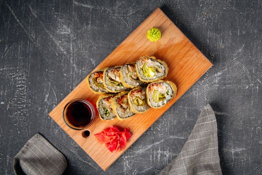 Roasted tempura sushi rolls with lettuce and sauce