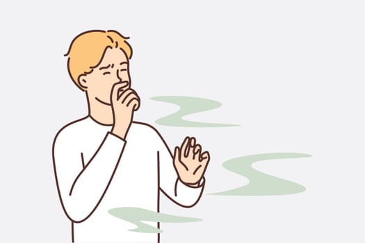 Man covers nose so as not to smell unpleasant smell from harmful production