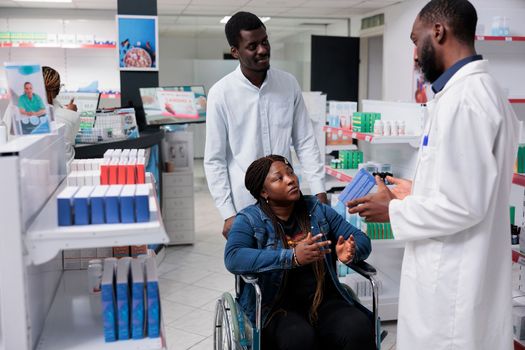 Woman in wheelchair choosing prescription treatment in drugstore