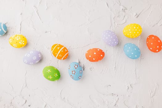 Happy Easter Day Concept. Top view holiday banner background web design white colorful easter eggs painted on cement background with empty copy space, celebration greeting card, overhead, template