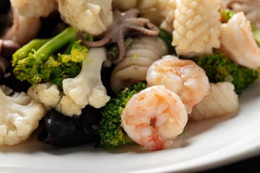 Closeup on portion of assorted seafood dish