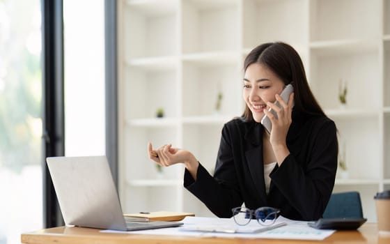 business woman talking smartphone with accountant consult and for calculating tax, financial report, Working with a business graph document report