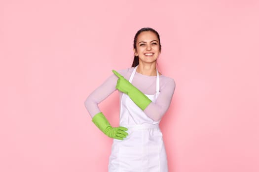 woman in rubber gloves pointing fingers aside at copyspace