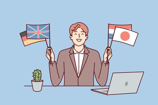 Satisfied man sits at table with laptop and shows flags of different countries. Vector image