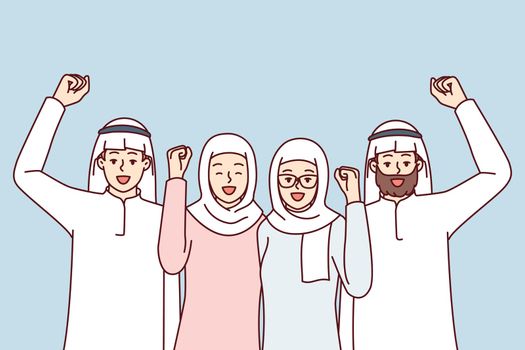 Team of people in arabic clothes make victory gestures rejoice at startup success