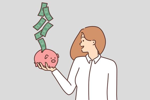 Smiling woman with piggybank excited with cash flow