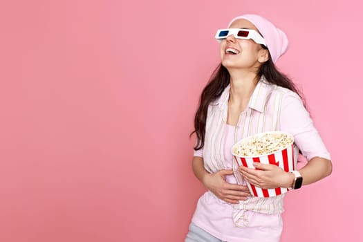 woman watching comedy holding bucket of popcorn