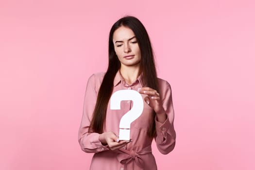 woman with question mark on pink background