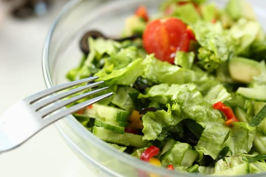 Delicious vitamin fresh salad with fresh lettuce tomatoes and cucumbers