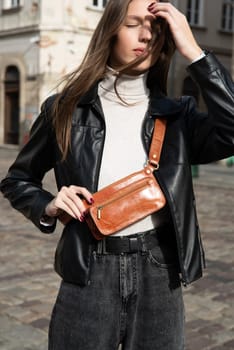 photo of a brown leather belt bag. street photo