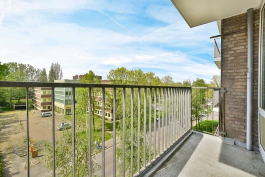 a balcony with a view of a building and trees