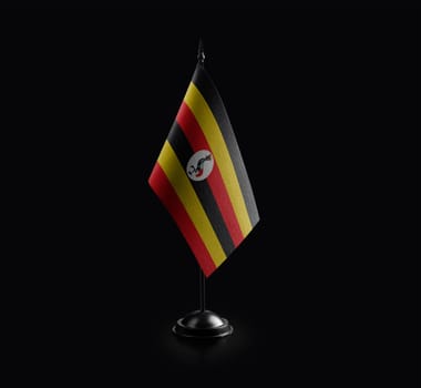 Small national flag of the Uganda on a black background